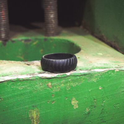 Silicone ring sitting on green tractor part.