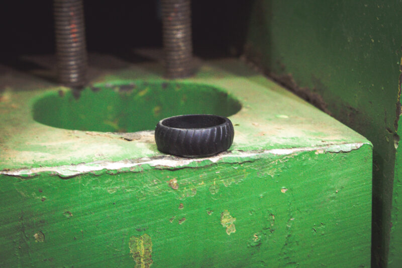 Silicone ring sitting on green tractor part.